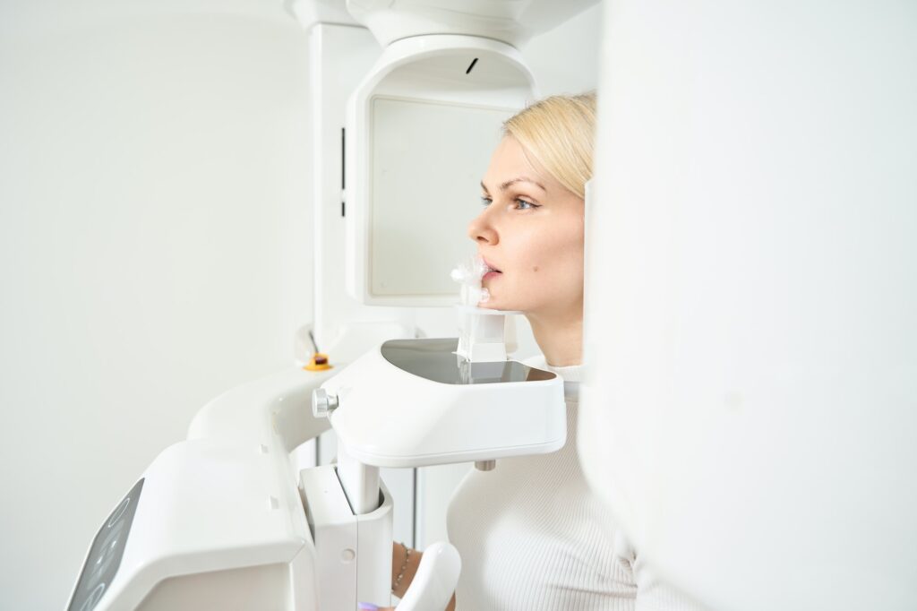 Woman in dental office next to x-ray  In St. Peters, MO