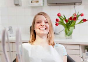 Happy patient smiling in dental chair at Majestic Dental in Cottleville, MO, exemplifying excellent dental care and patient satisfaction.