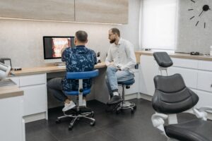 Dentist reviewing digital dental images with a patient during a comprehensive smile evaluation to discuss personalized treatment options for restoring oral health and function.